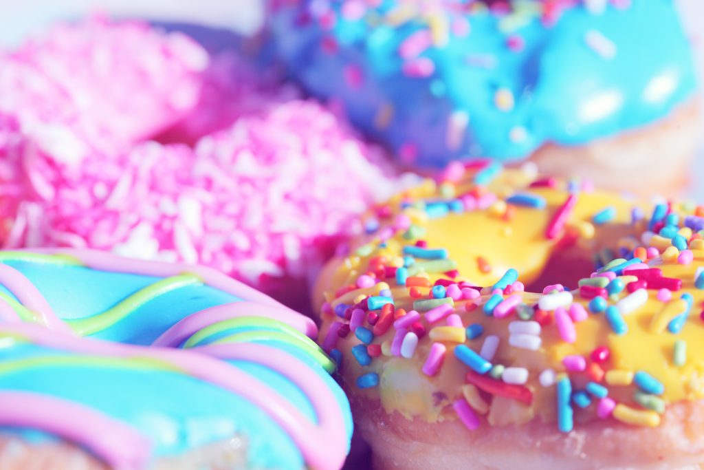 close up photo of donuts with sprinkles